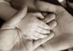 Holding-child-hand-Charlotte-Mooresville-Child-Custody-Lawyer-300x210