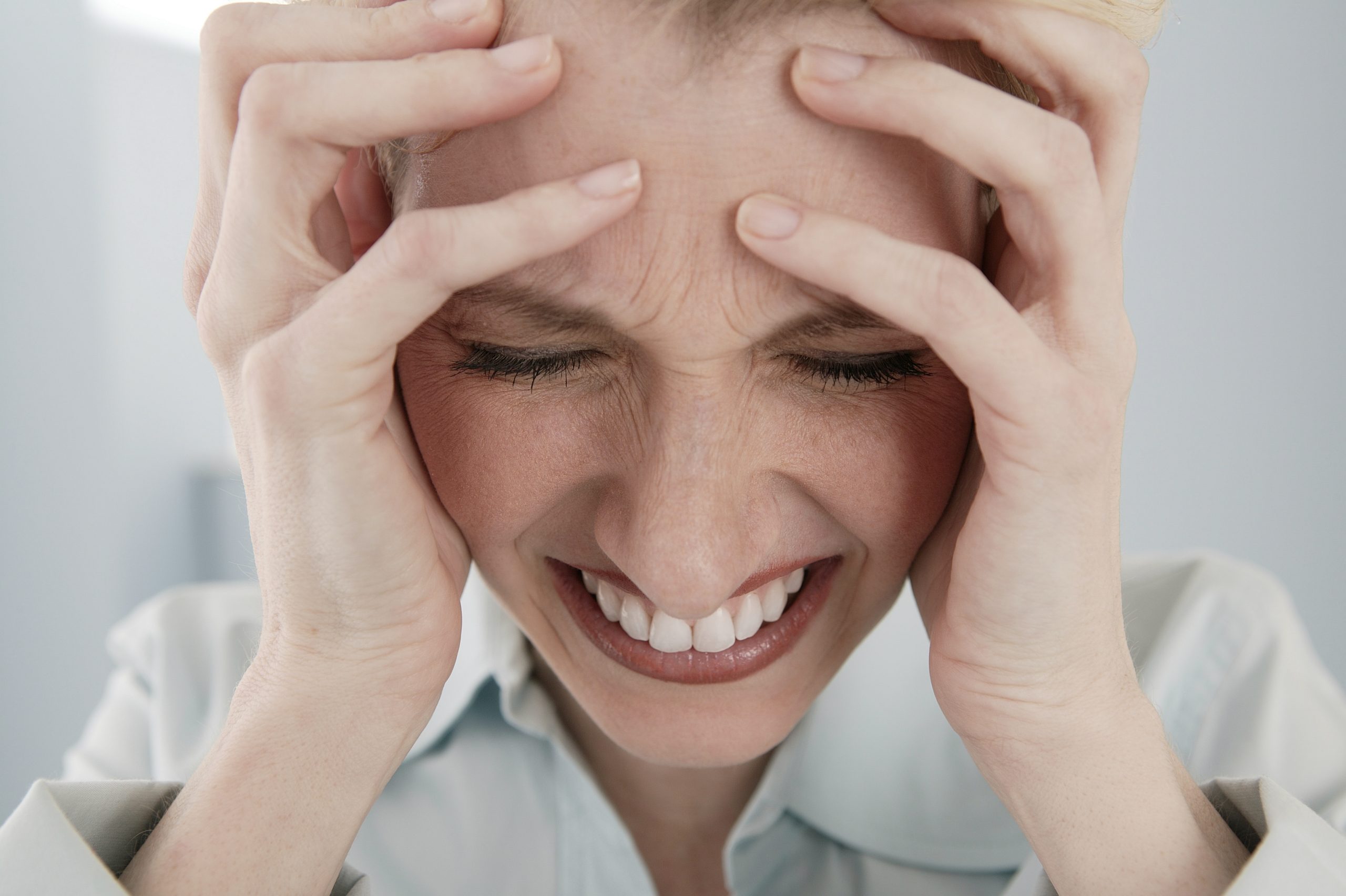 upset-woman-holding-her-head-2202966-scaled